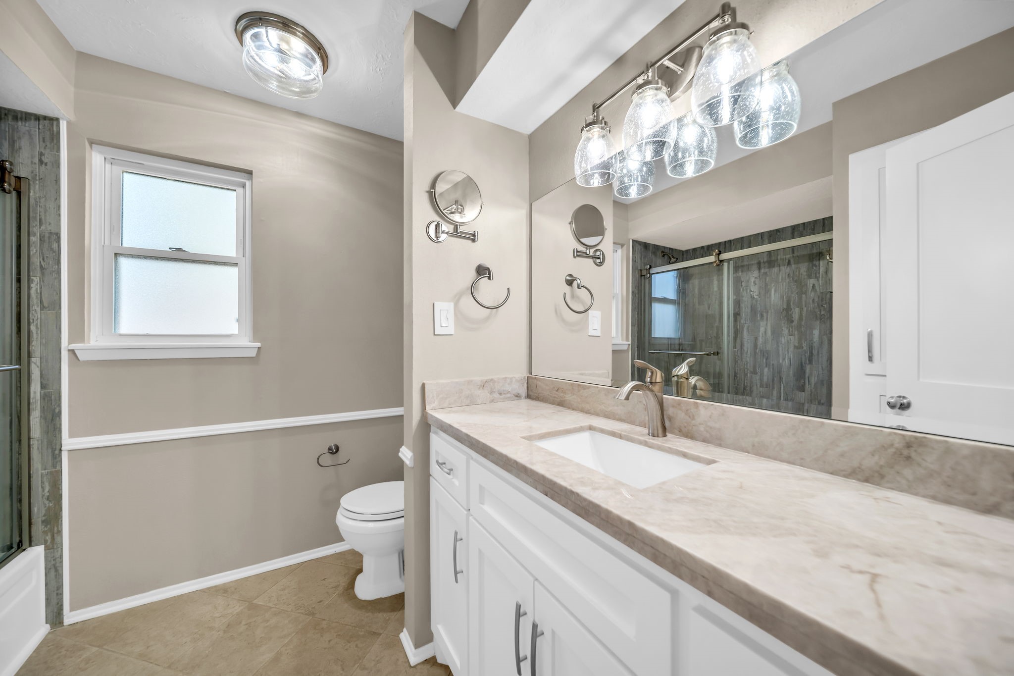115 Heather Lane Conroe, TX 77385 - Photo 21 of 28 a bathroom with a granite countertop sink a toilet and a mirror