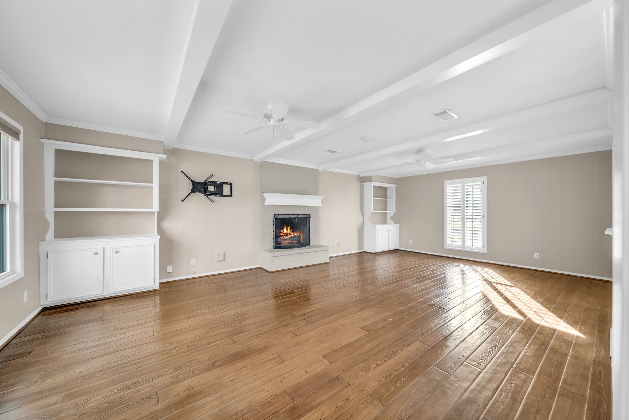 115 Heather Lane Conroe, TX 77385 - Photo 4 of 28 an empty room with wooden floor and windows