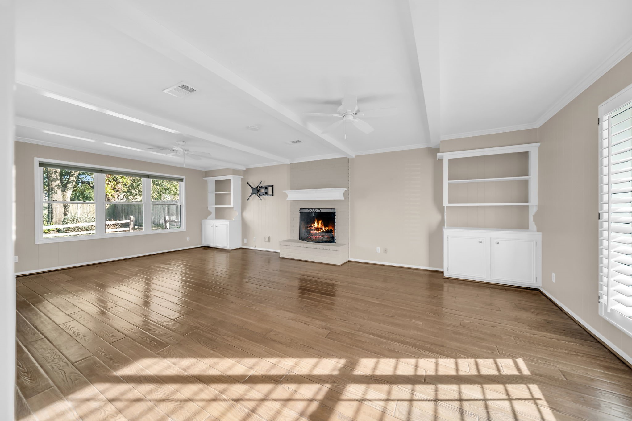 115 Heather Lane Conroe, TX 77385 - Photo 5 of 28 a view of an empty room with a window and wooden floor