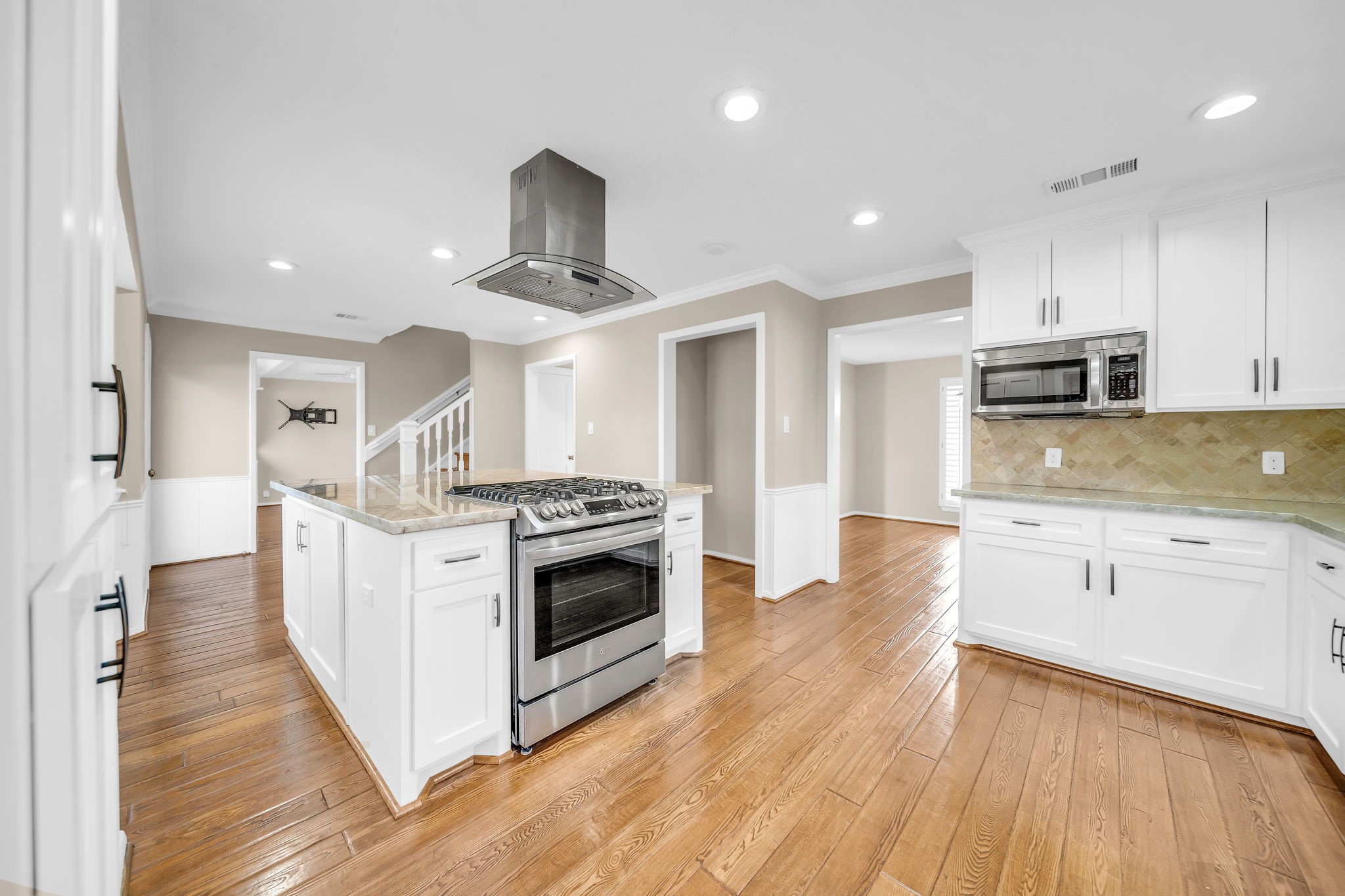 115 Heather Lane Conroe, TX 77385 - Photo 6 of 28 a large kitchen with stainless steel appliances granite countertop a stove and a sink