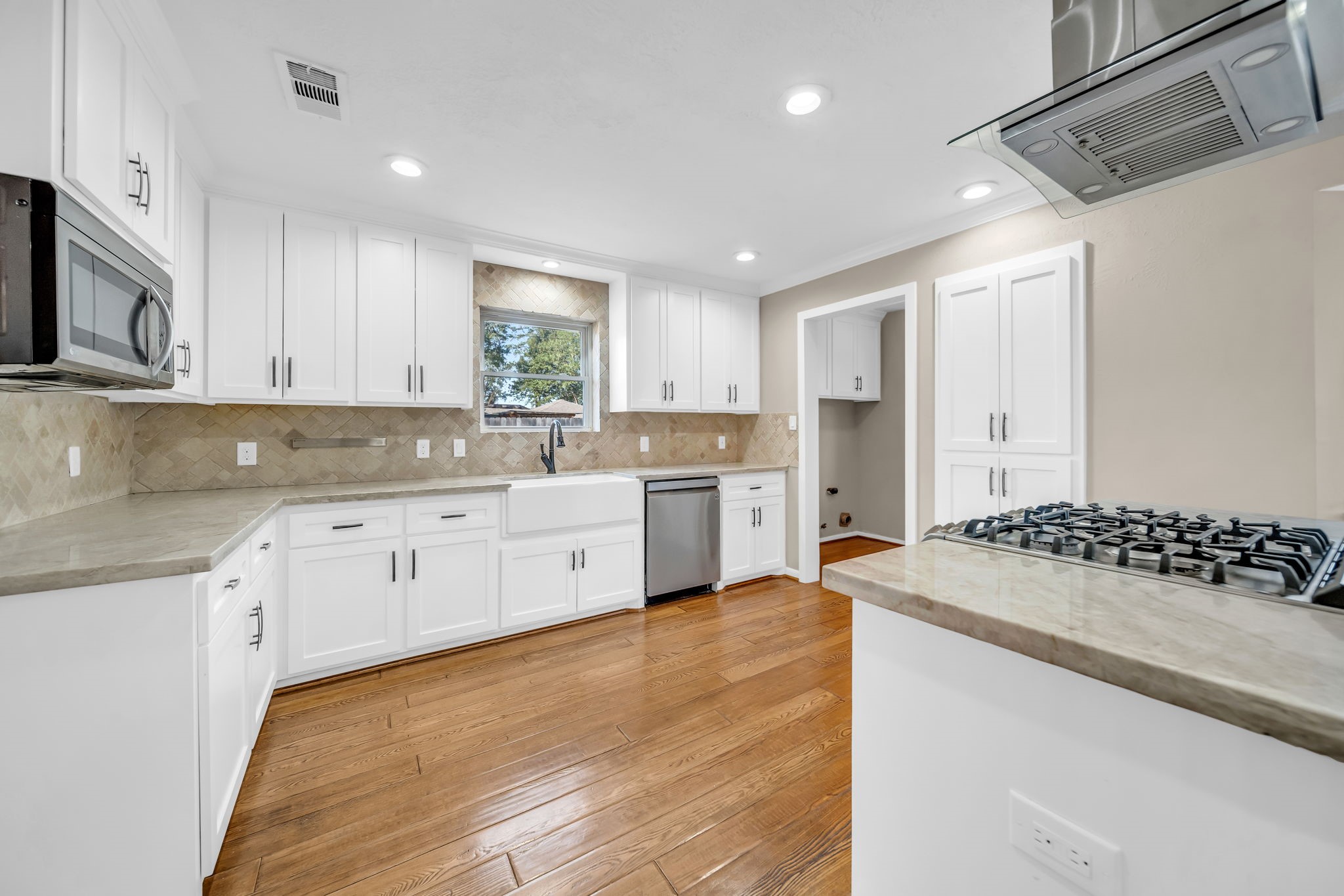 115 Heather Lane Conroe, TX 77385 - Photo 7 of 28 a kitchen with granite countertop a sink stove and cabinets