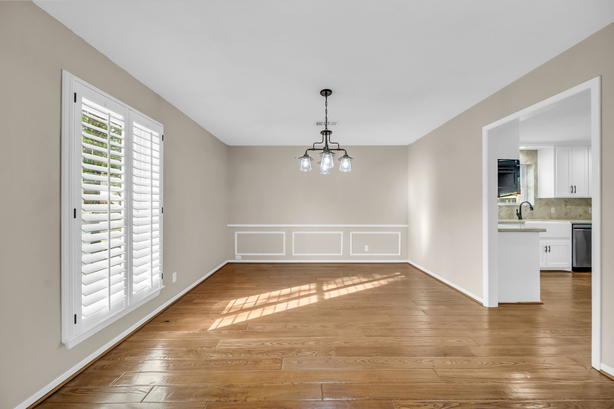 115 Heather Lane Conroe, TX 77385 - Photo 10 of 28 a view of a big room with wooden floor windows and a kitchen view