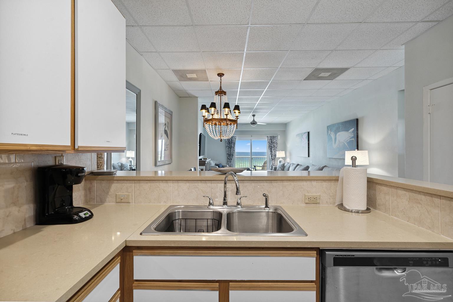 999 Fort Pickens Road, Unit 204 Pensacola Beach, FL 32561 - Photo 18 of 48 a kitchen with a sink and a refrigerator