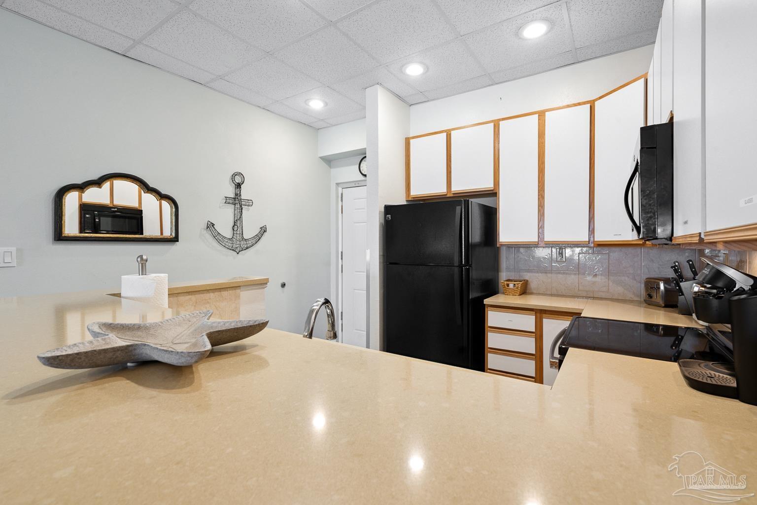 999 Fort Pickens Road, Unit 204 Pensacola Beach, FL 32561 - Photo 20 of 48 a kitchen with a refrigerator and a sink