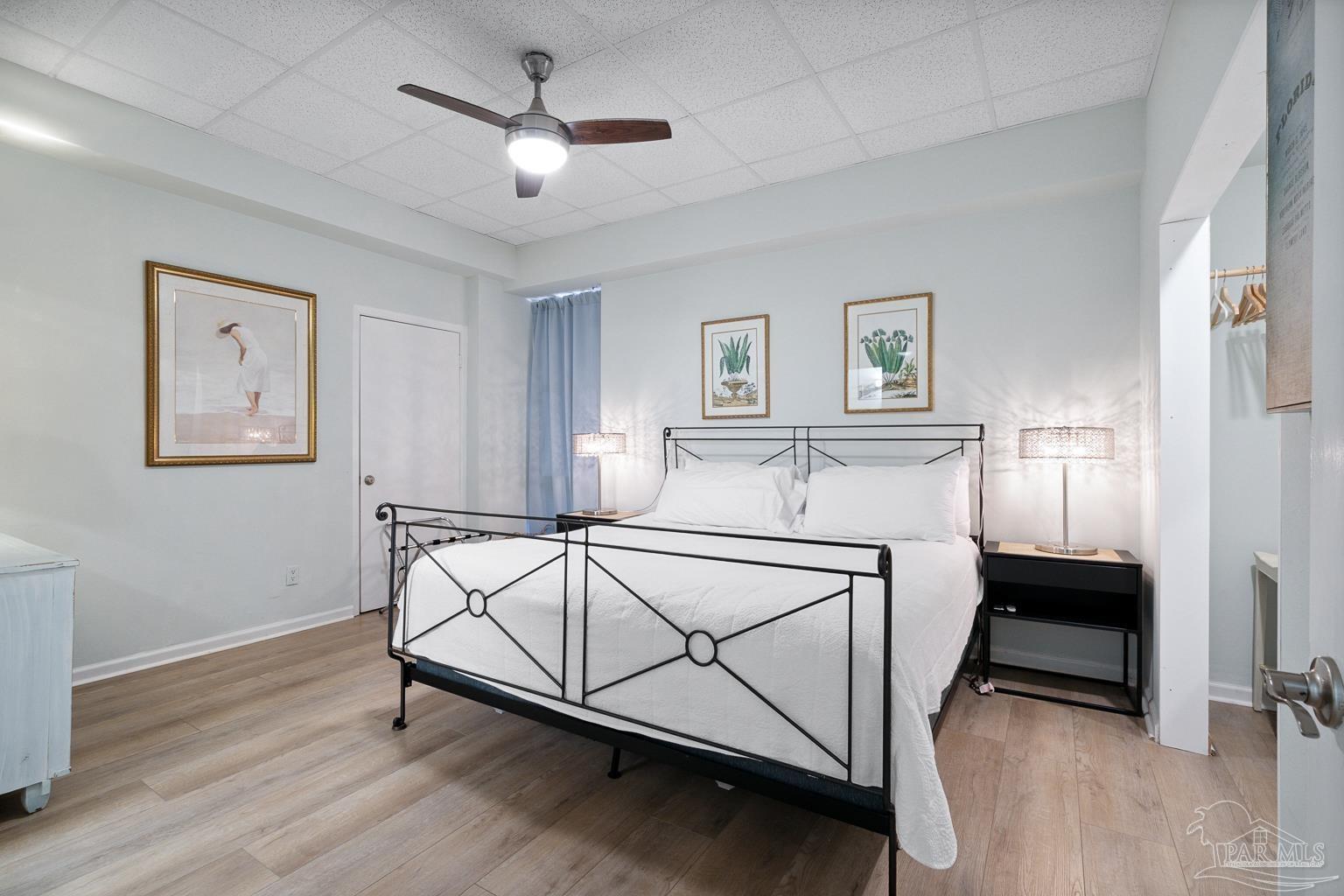 999 Fort Pickens Road, Unit 204 Pensacola Beach, FL 32561 - Photo 21 of 48 a bedroom with a bed and a chandelier