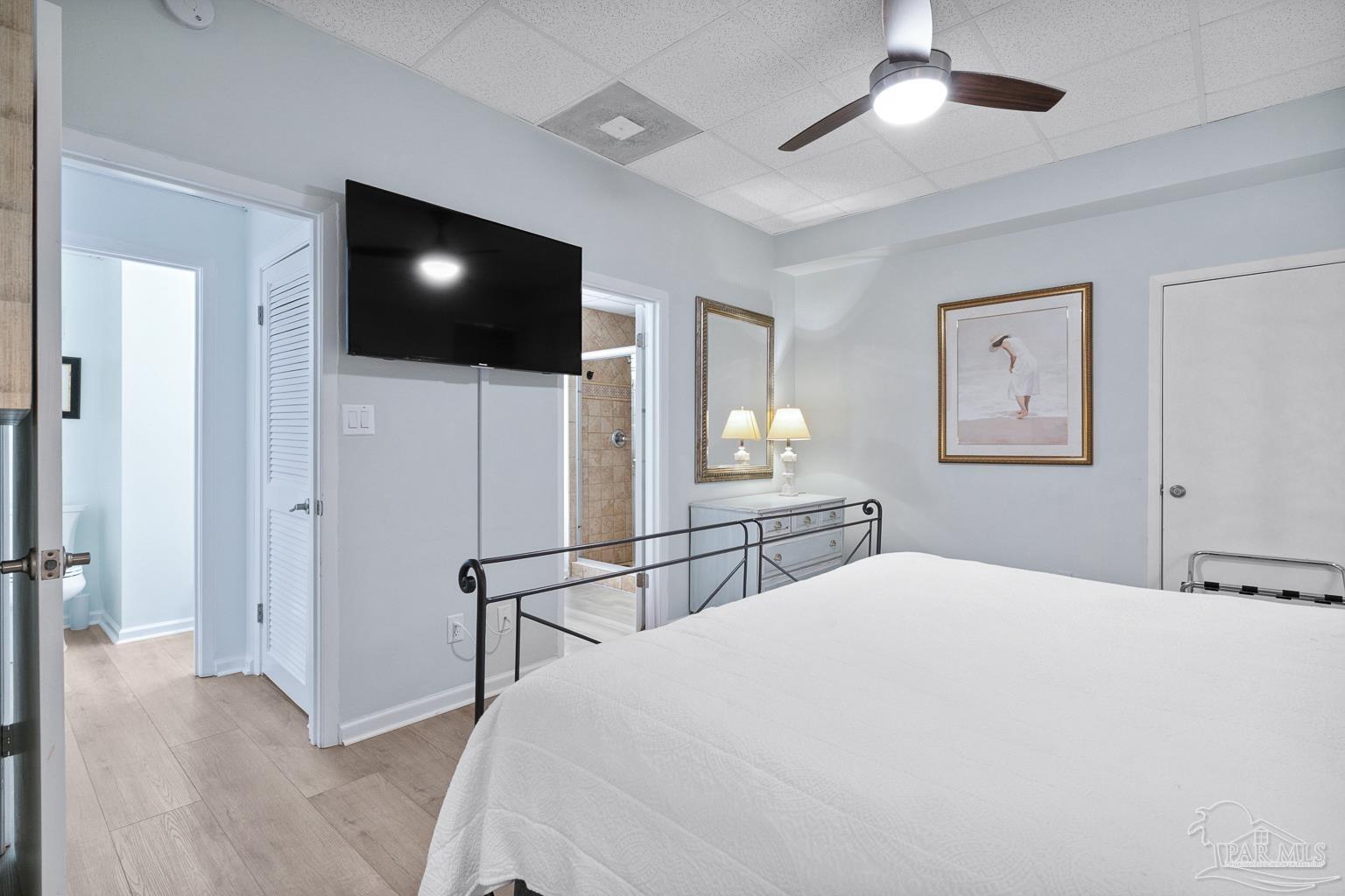 999 Fort Pickens Road, Unit 204 Pensacola Beach, FL 32561 - Photo 23 of 48 a bedroom with a bed and a flat screen tv