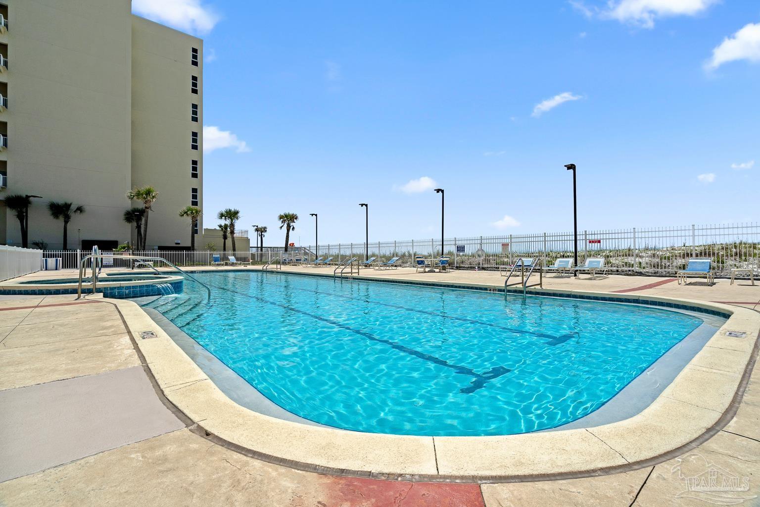 999 Fort Pickens Road, Unit 204 Pensacola Beach, FL 32561 - Photo 39 of 48 a view of a swimming pool with a lounge chair