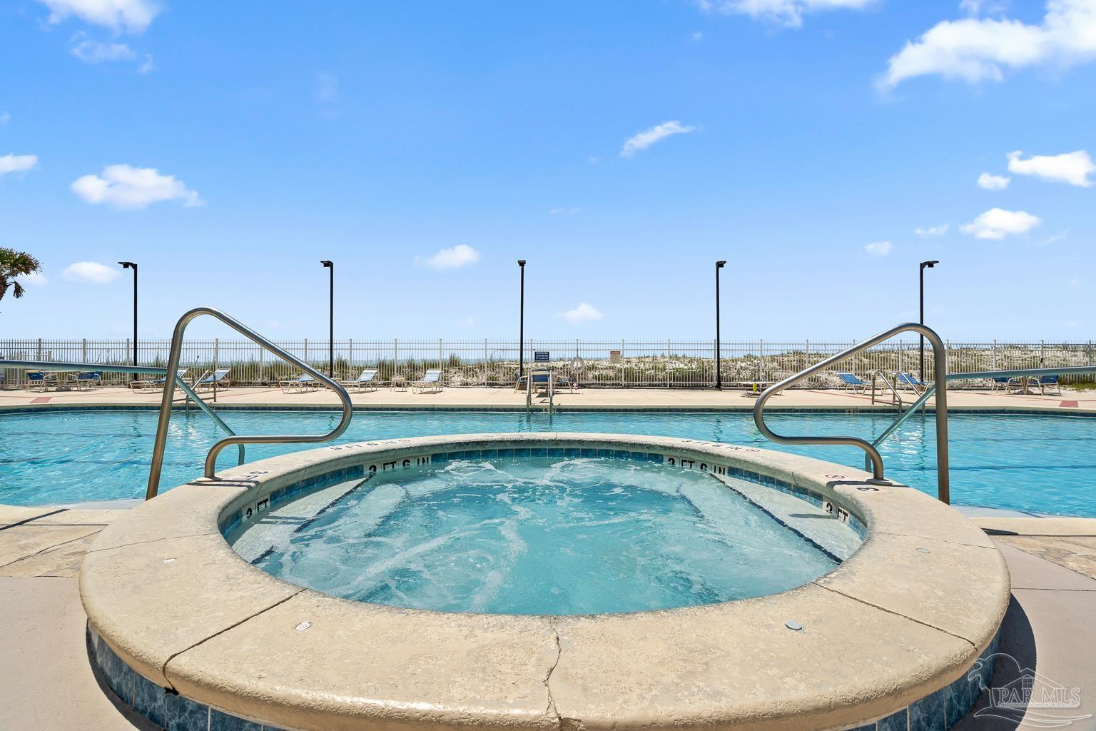 999 Fort Pickens Road, Unit 204 Pensacola Beach, FL 32561 - Photo 42 of 48 a view of a swimming pool with a lake view