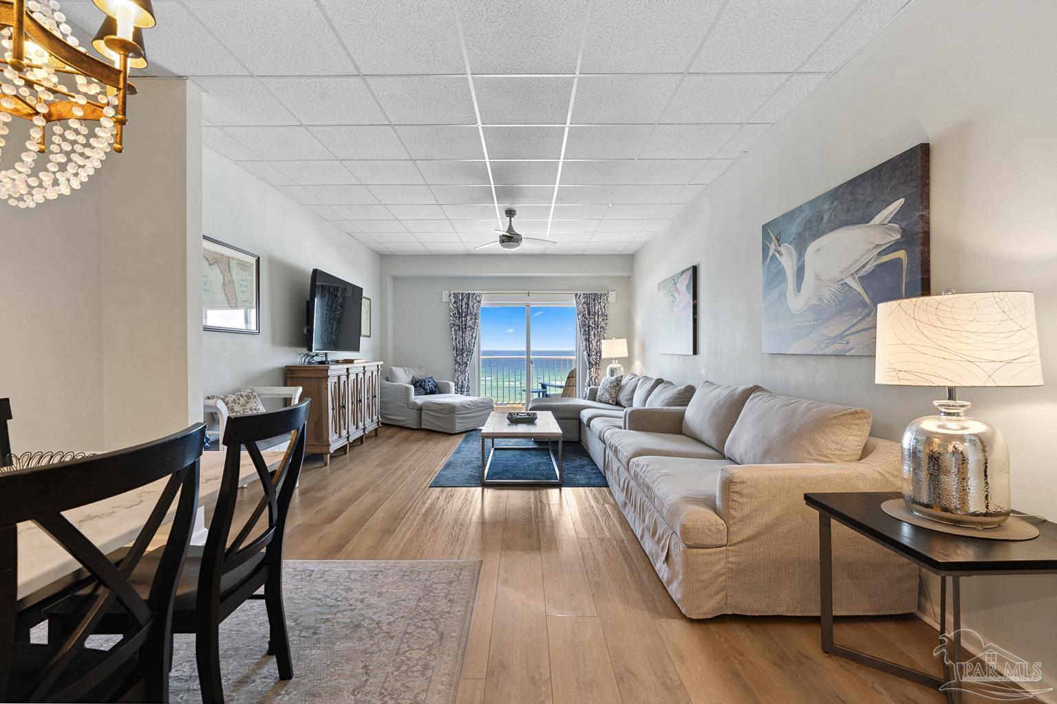 999 Fort Pickens Road, Unit 204 Pensacola Beach, FL 32561 - Photo 10 of 48 a living room with furniture and a chandelier