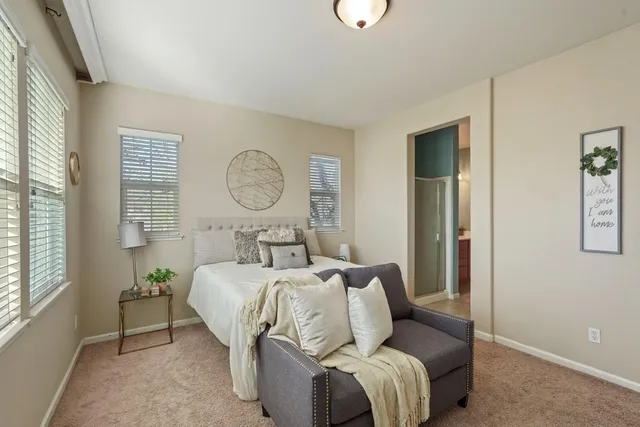 a bed room with a bed mirror and a window