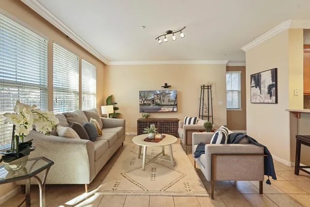 a living room with furniture and floor to ceiling windows