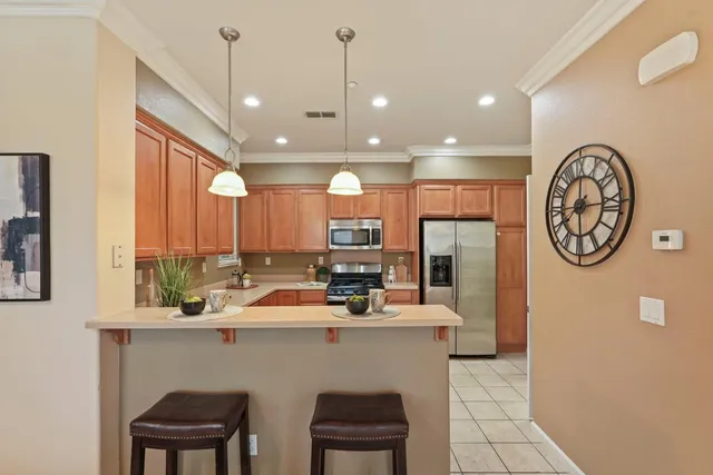 a kitchen with a refrigerator a sink and a table