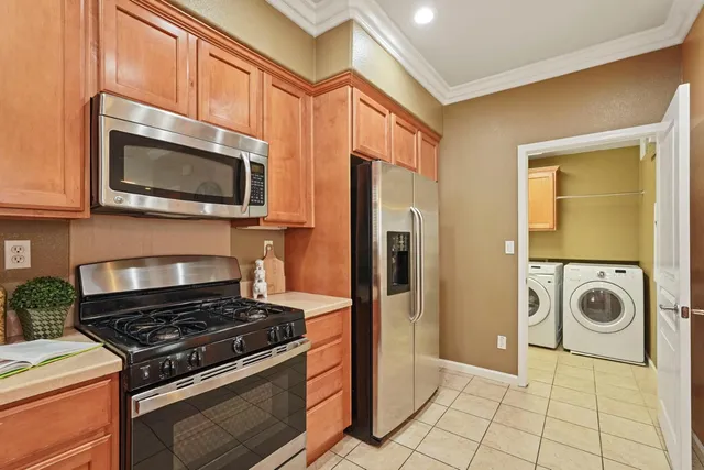 a kitchen with granite countertop a stove and a microwave