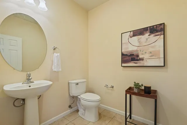 a bathroom with a toilet a sink and mirror