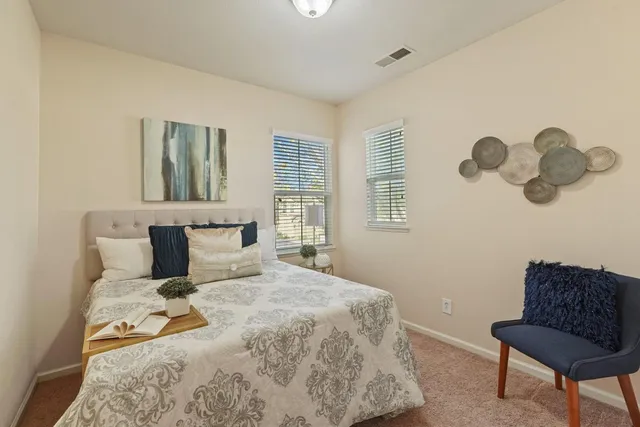 a bedroom with a bed and window