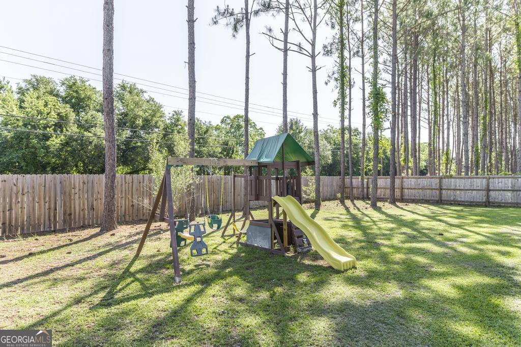 609 Live Oak Way Dublin, GA 31021 - Photo 35 of 37 a view of a backyard with a small pool
