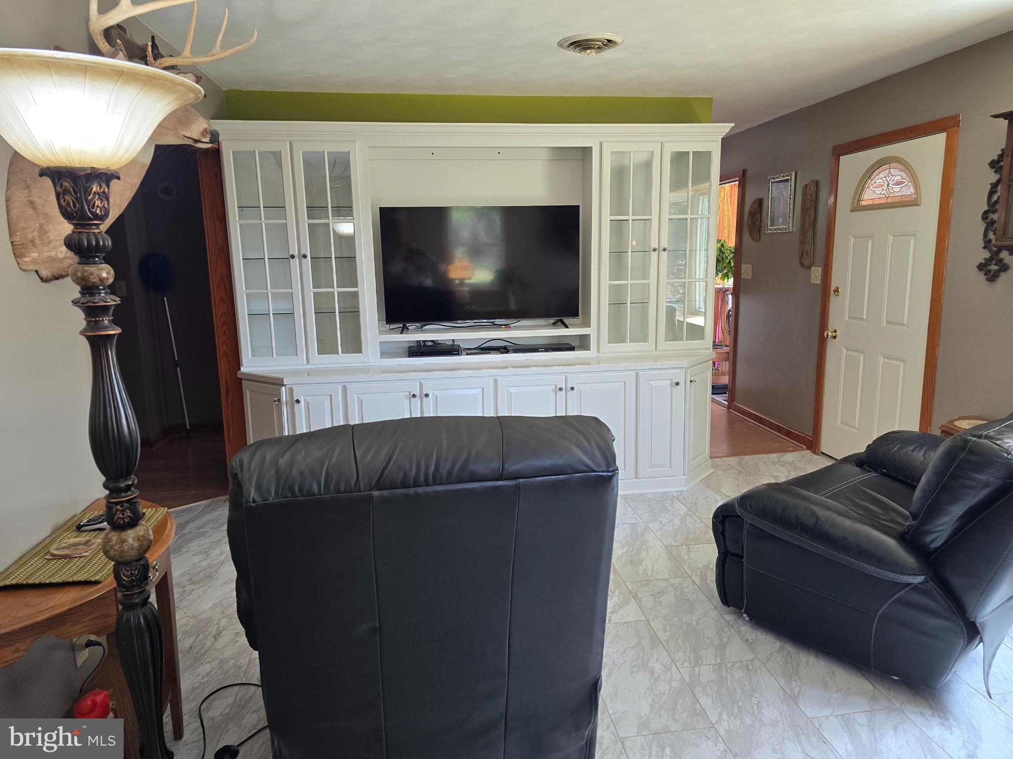 18631 Cherryfield Road Drayden, MD 20630 - Photo 11 of 45 a living room with furniture and a flat screen tv