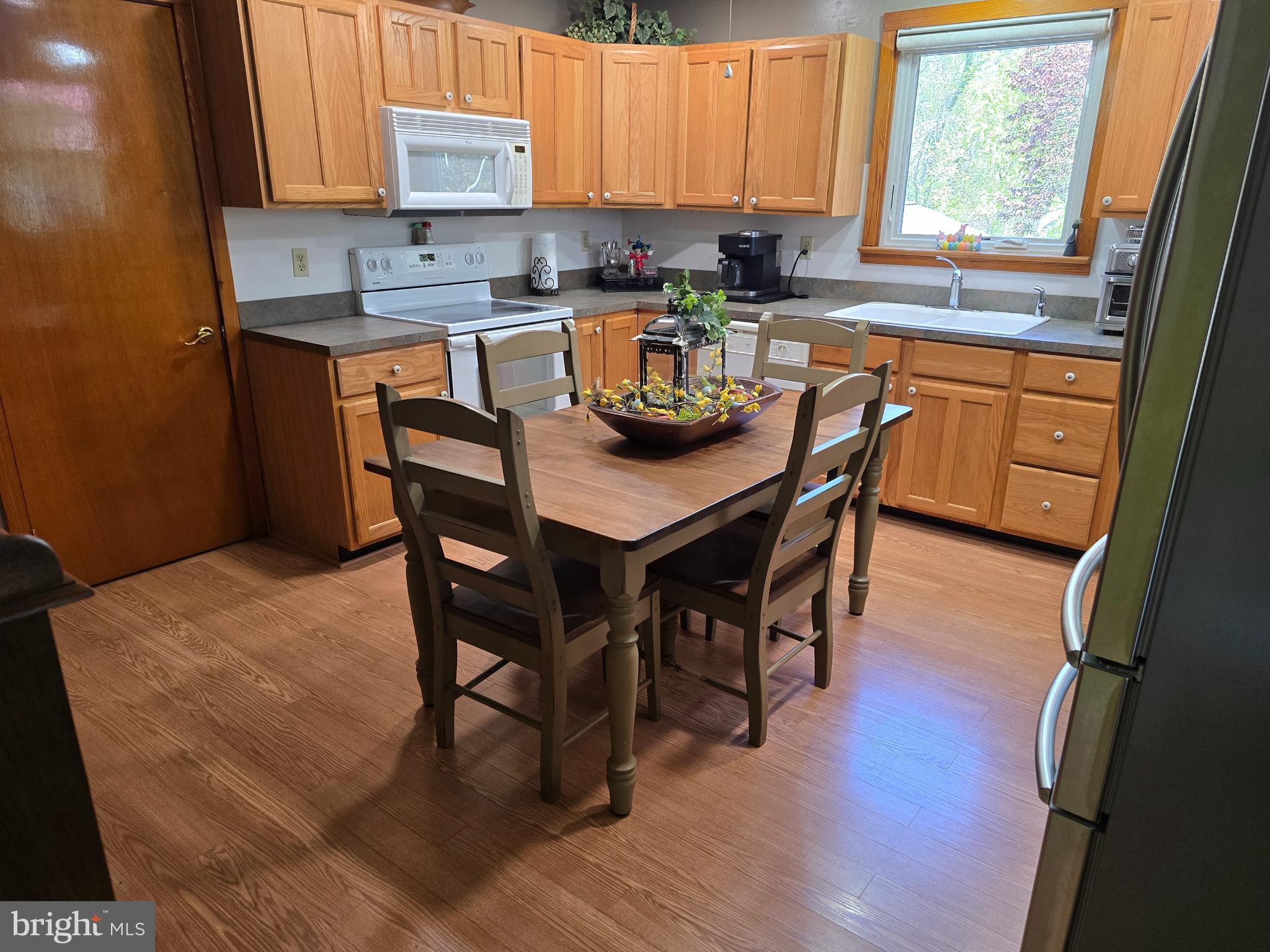 18631 Cherryfield Road Drayden, MD 20630 - Photo 13 of 45 a kitchen with granite countertop wooden floors and wooden cabinets