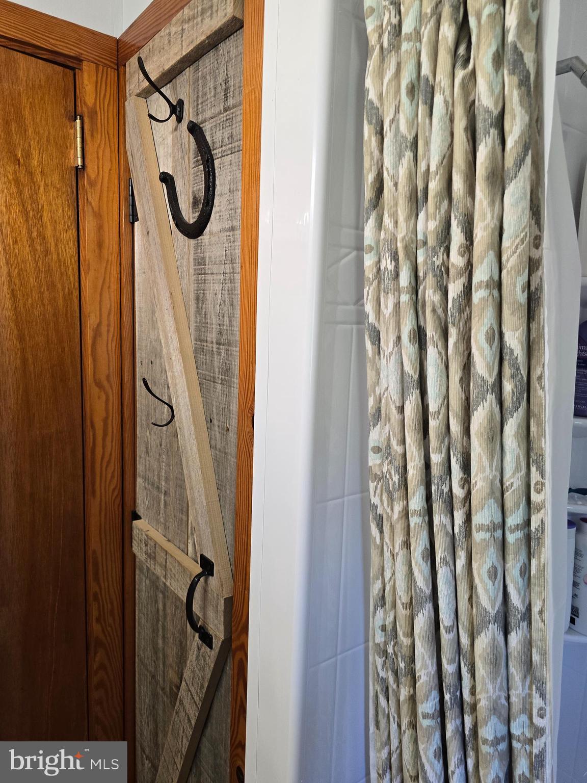 18631 Cherryfield Road Drayden, MD 20630 - Photo 27 of 45 a bathroom with a shower curtain and a window