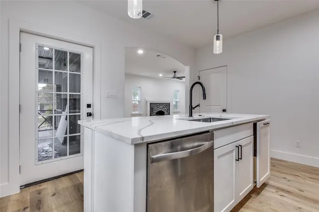 a kitchen with a sink and cabinets