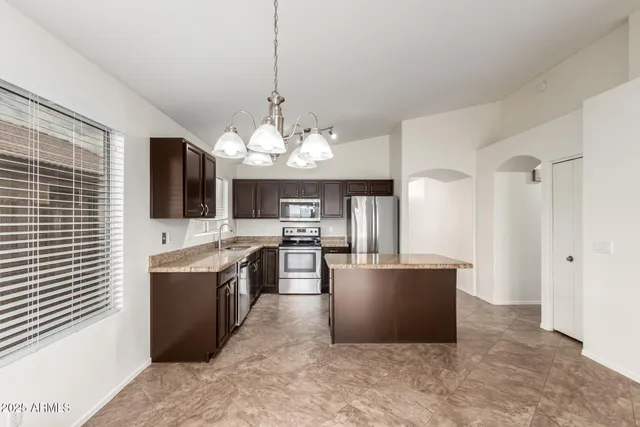 a view of a kitchen with a sink and cabinets