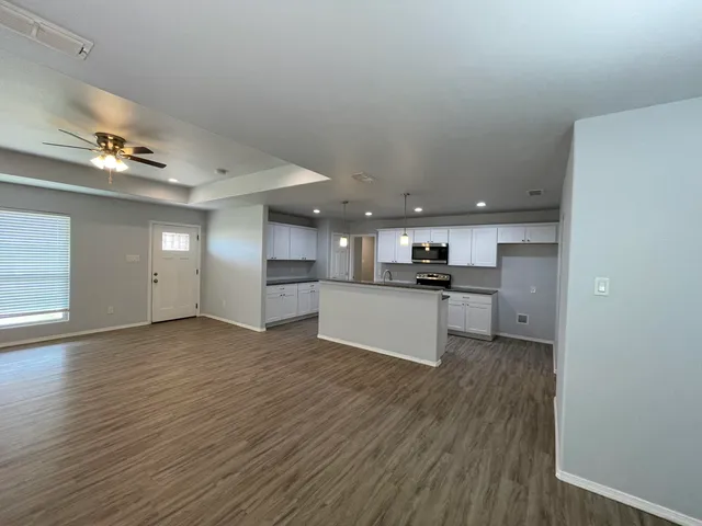 a view of kitchen view with wooden floor and electronic appliances