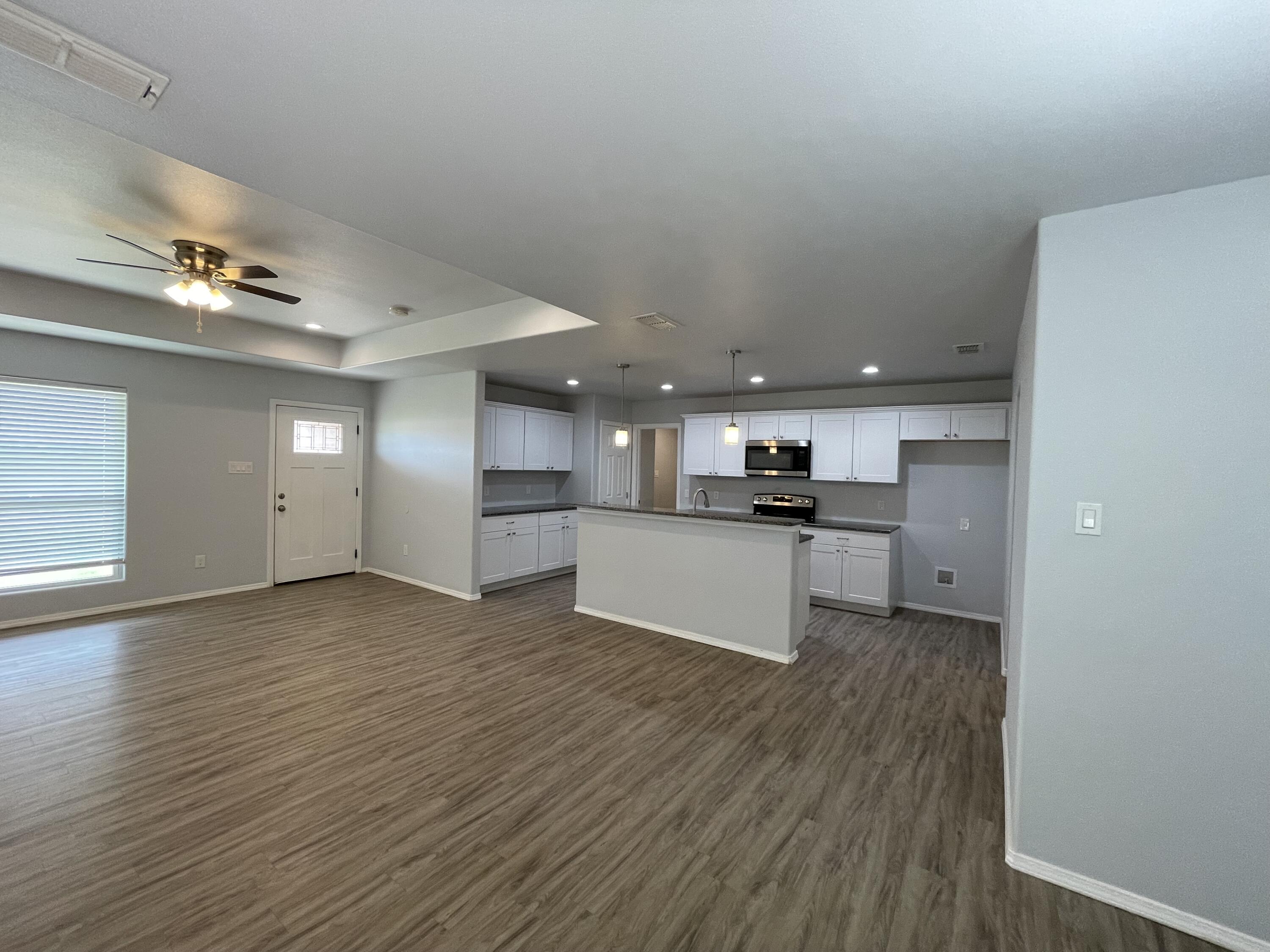 8410 11th Street Lubbock, TX 79416 - Photo 4 of 13 a view of kitchen view with wooden floor and electronic appliances