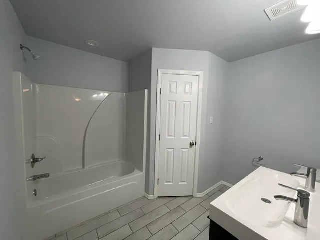 a bathroom with a sink and a shower