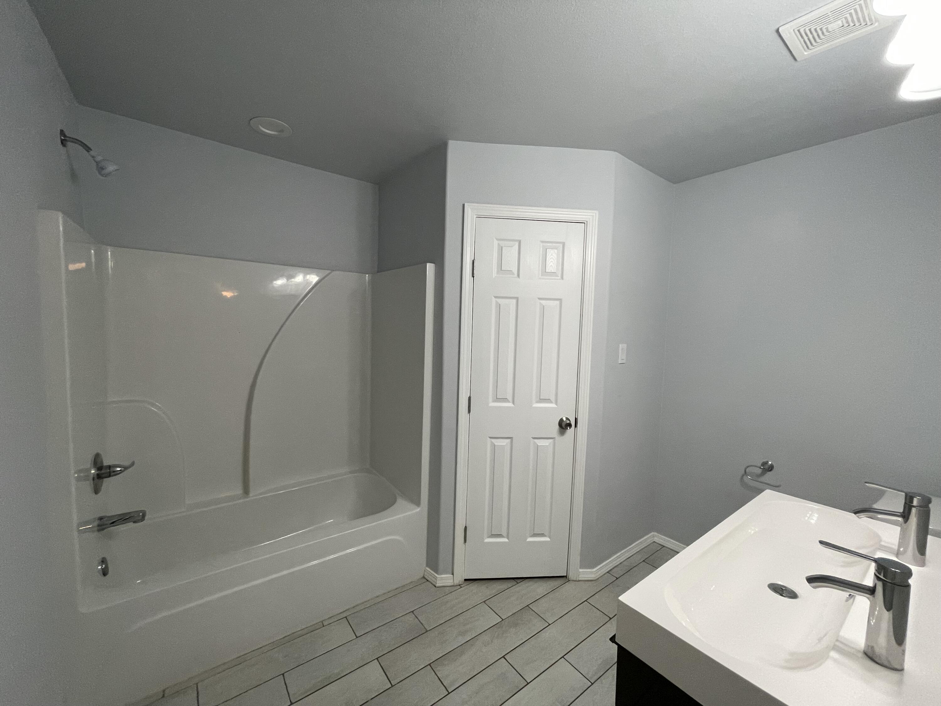 8410 11th Street Lubbock, TX 79416 - Photo 8 of 13 a bathroom with a sink and a shower