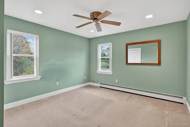 a view of room with window and ceiling fan