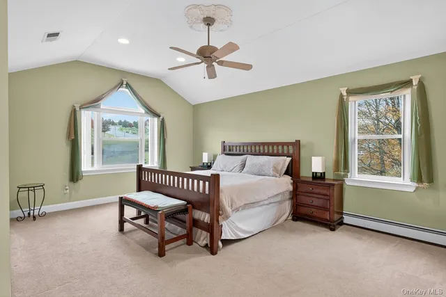 a spacious bedroom with a bed and a window