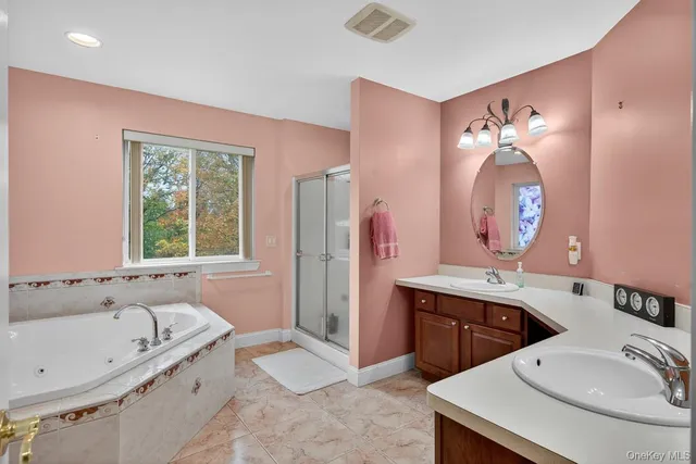 a spacious bathroom with a sink a bathtub and a window