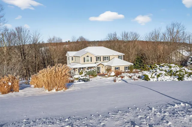 a view of a house with yard and sitting area