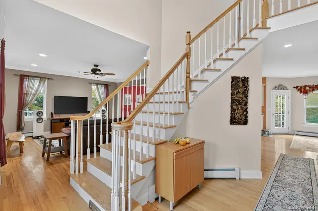 a view of entryway and hall with wooden floor