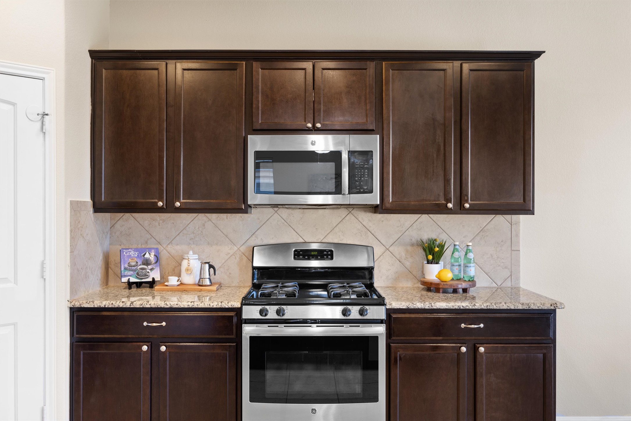 18120 Moreto Loop Pflugerville, TX 78660 - Photo 11 of 28 Kitchen featuring granite counters and decorative backsplash