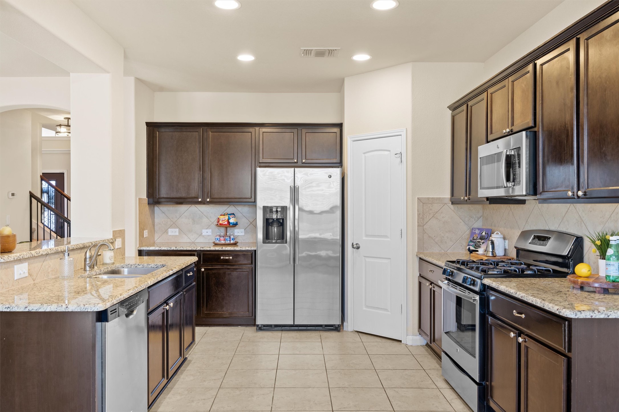 18120 Moreto Loop Pflugerville, TX 78660 - Photo 6 of 29 a kitchen with stainless steel appliances granite countertop a sink stove and refrigerator