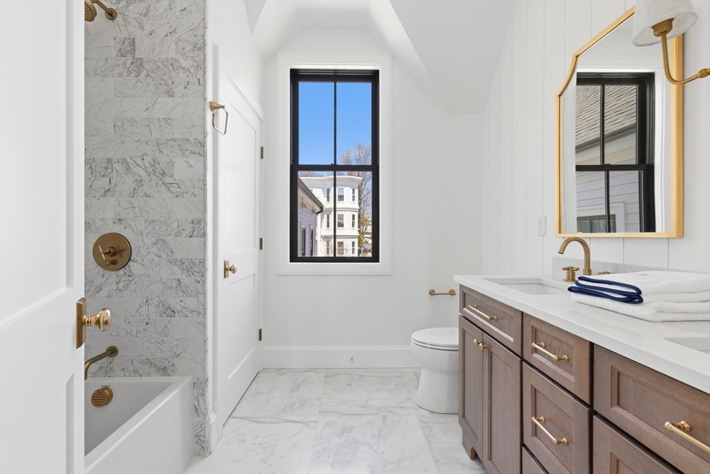 847 East 5th Street, Unit 2 Boston, MA 02127 - Photo 22 of 24 a bathroom with a granite countertop sink a toilet and shower