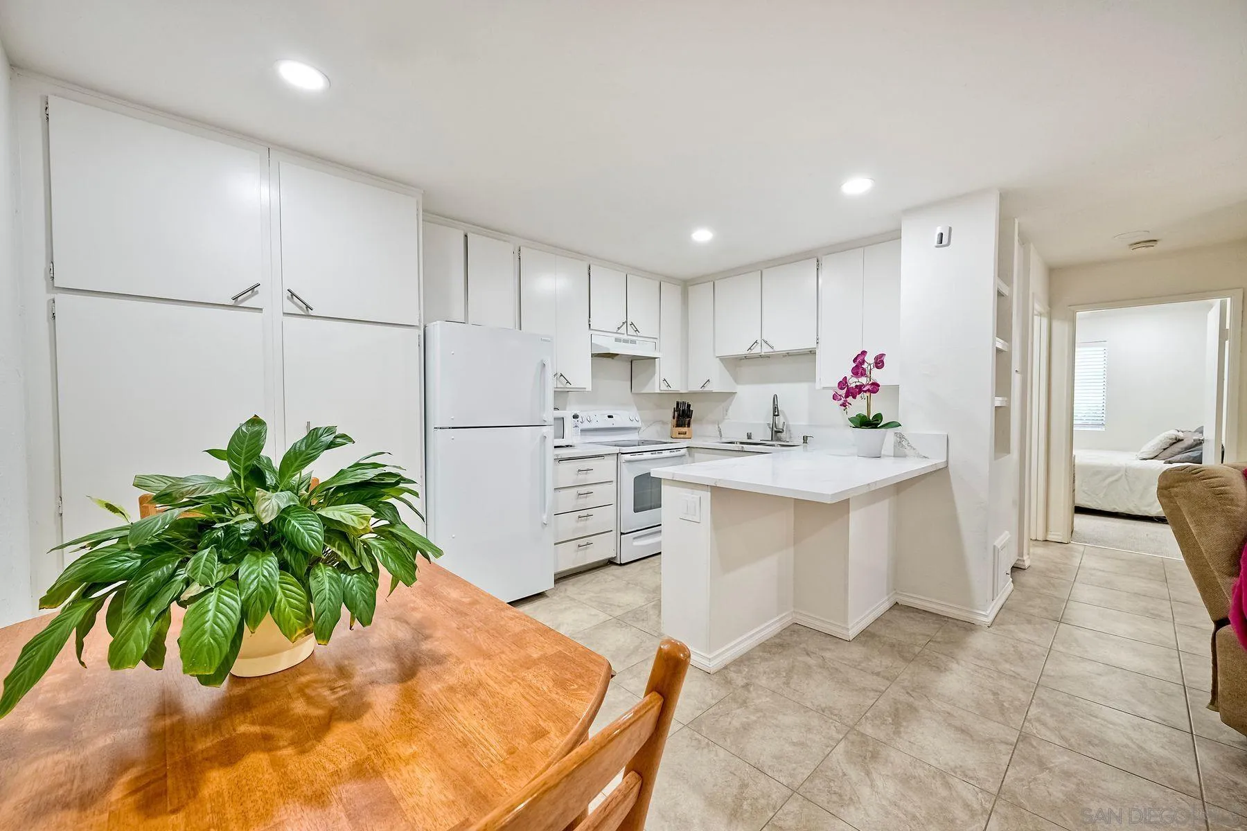 a kitchen with sink and refrigerator