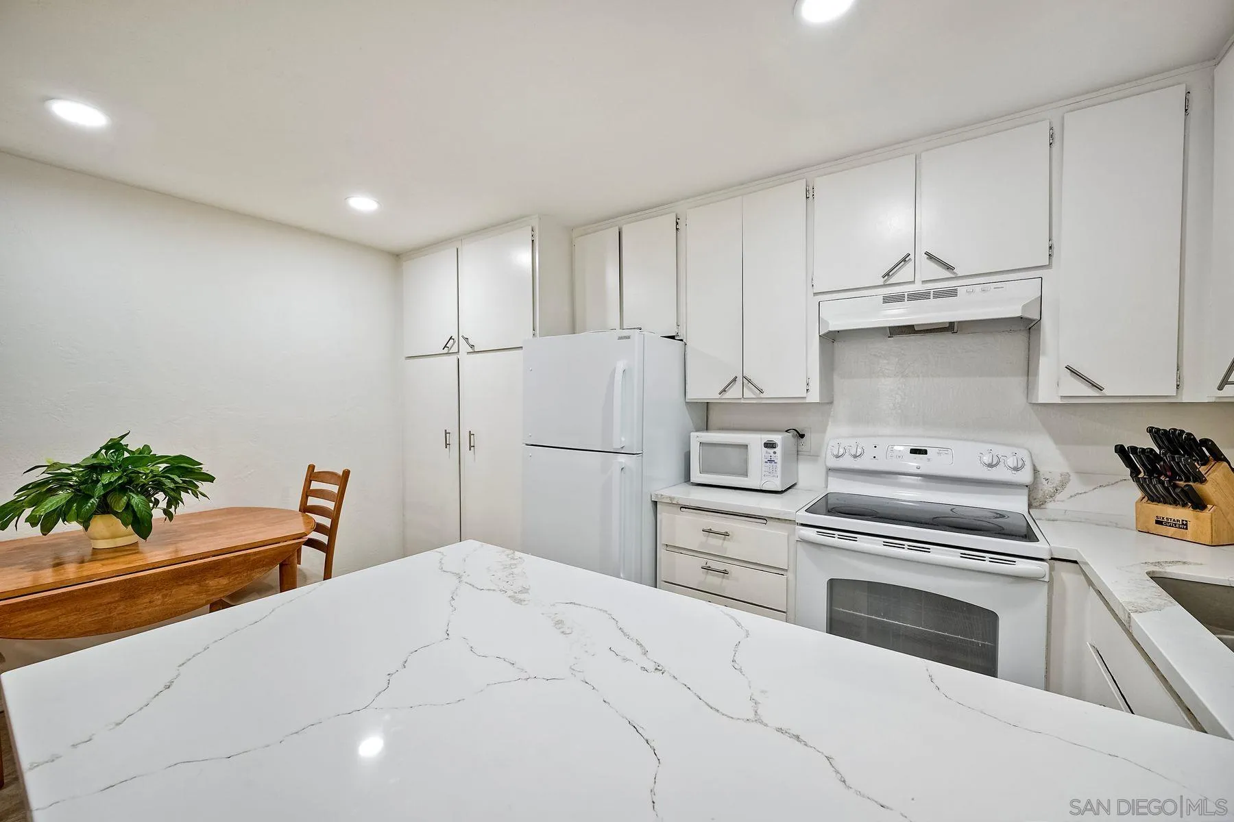 6358 Rancho Mission Road, Unit 623 San Diego, CA 92108 - Photo 7 of 21 a kitchen with appliances cabinets and a counter space