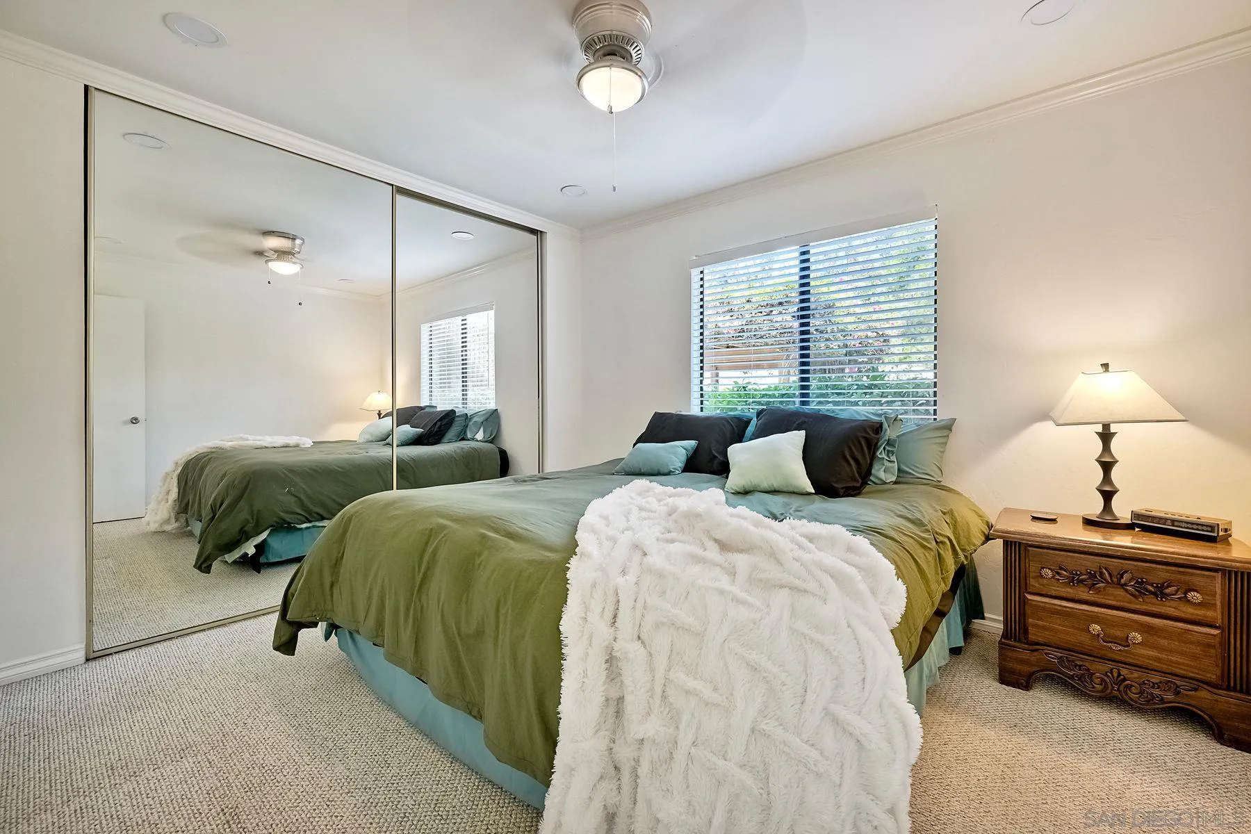 6358 Rancho Mission Road, Unit 623 San Diego, CA 92108 - Photo 9 of 21 a bedroom with two beds and a chandelier