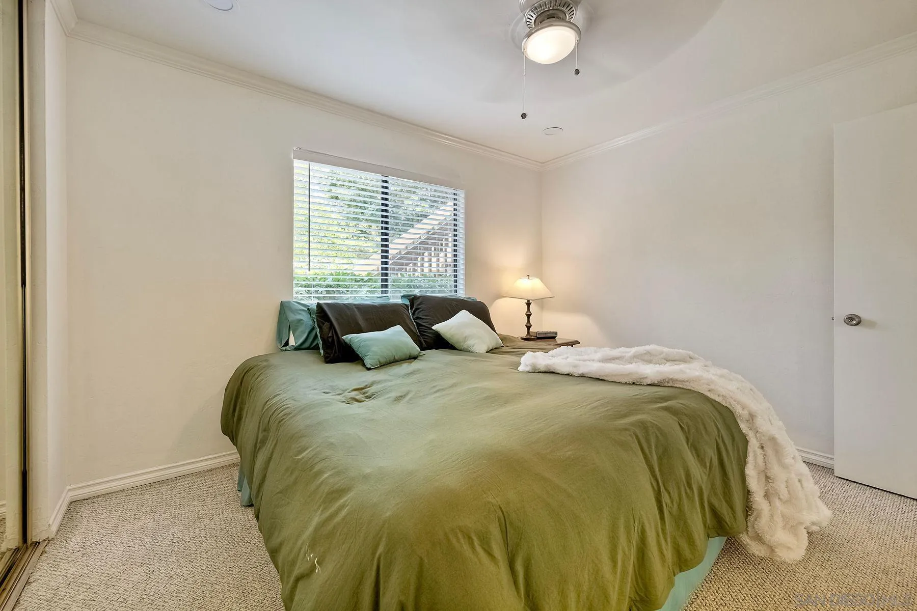 6358 Rancho Mission Road, Unit 623 San Diego, CA 92108 - Photo 10 of 21 a bed sitting in a bedroom next to a window