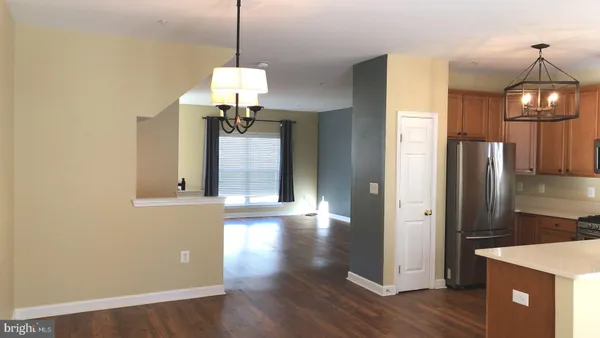 a view of a room with wooden floor wooden floor and windows