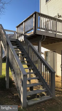 a view of staircase with wooden floor and white walls