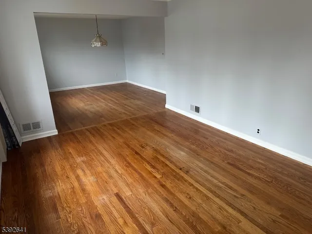 a view of a room with wooden floor
