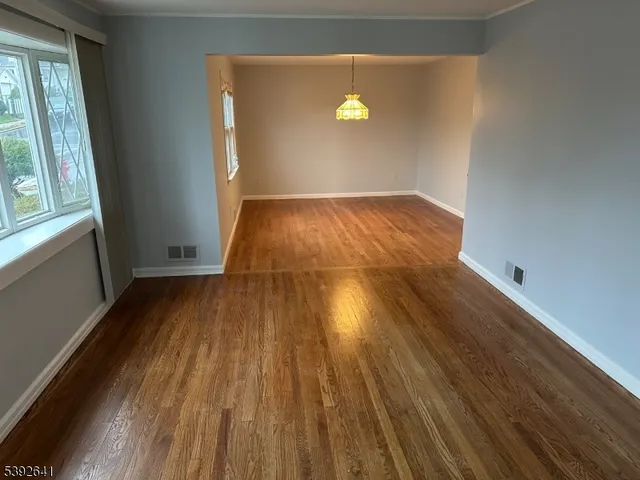 a view of a room with wooden floor