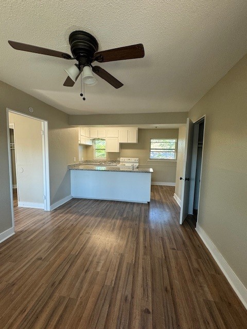 4706 Yellowstone Boulevard, Unit 12 Houston, TX 77021 - Photo 13 of 23 a view of kitchen and empty room with wooden floor
