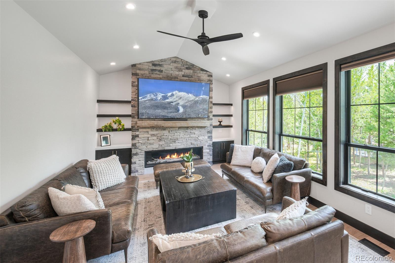 306 Golden Eagle Road Silverthorne, CO 80498 - Photo 12 of 43 a living room with furniture a large window and a fireplace