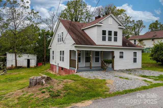 a view of a house with a yard patio and fire pit