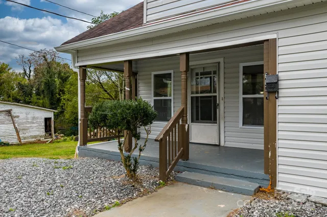 a view of house with a large window and stairs