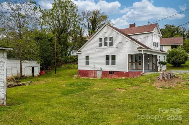 a view of a house with a yard porch and sitting area